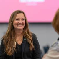 Beth Emmitt talking with other guest at event